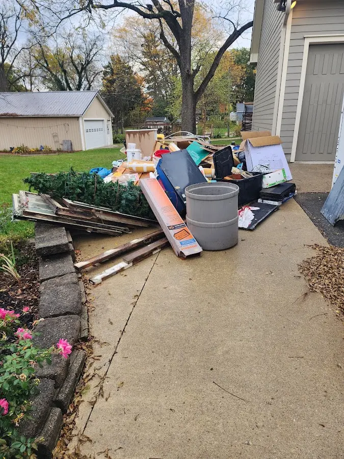 Dumpster being loaded with debris for Estate Cleanout Dumpster Rental in Albert Lea
